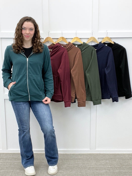Women's full zip hooded sweatshirt in teal, burgundy, brown, olive green, navy, and black with long sleeves, front pockets, and relaxed fit.
