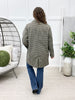 Back view of women's black and cream houndstooth coat featuring an allover pattern, long sleeves, and center back vent.